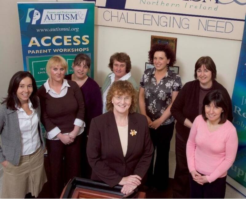 A group of women smile and pose together