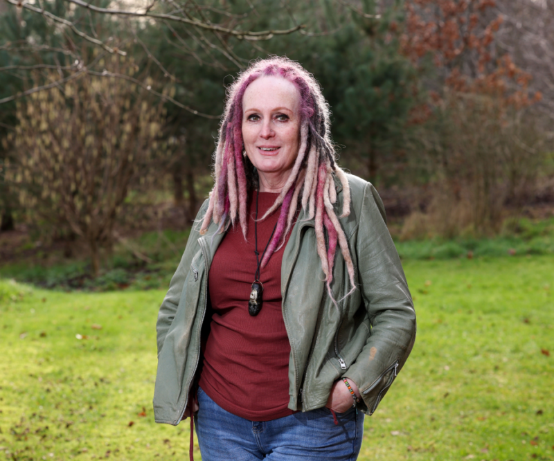 Woman smiles for a photograph while outdoors