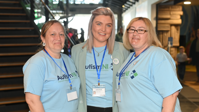 A group of Autism NI volunteers wearing Autism NI T-shirts