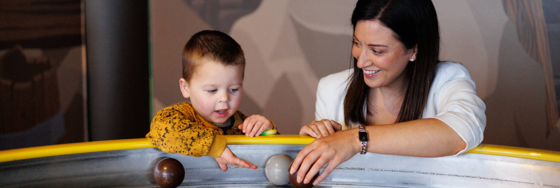 CEO Kerry smiles and plays with a child