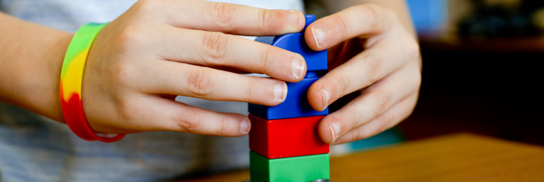 A child's hands using building blocks
