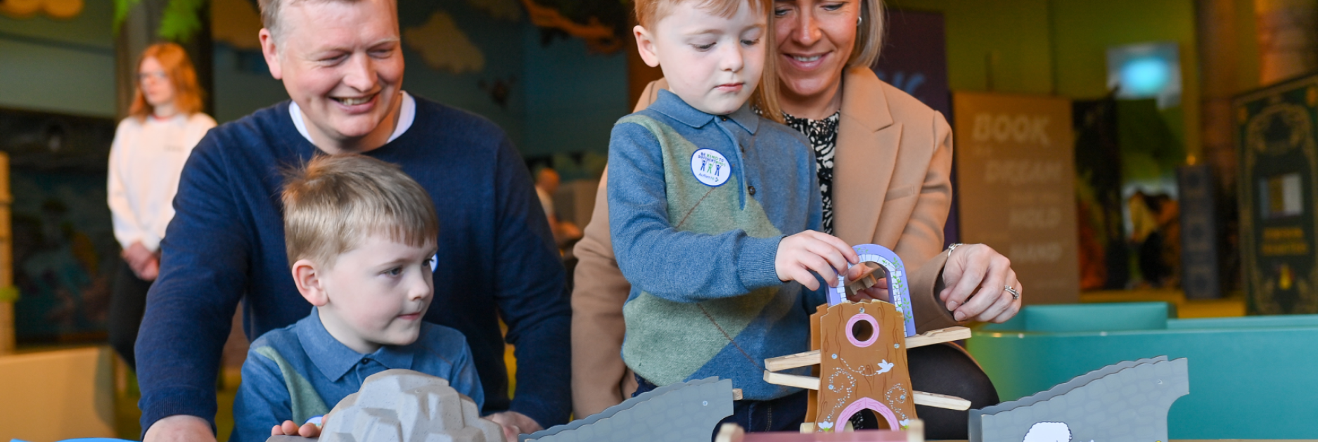 A family smiling and playing with toys together